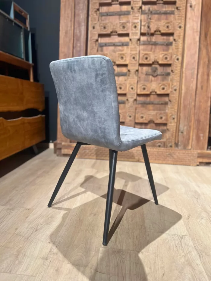 Une chaise de salle à manger en velours gris