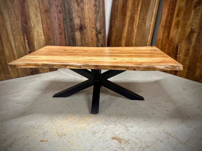 Une table basse avec un pied en forme d'étoile