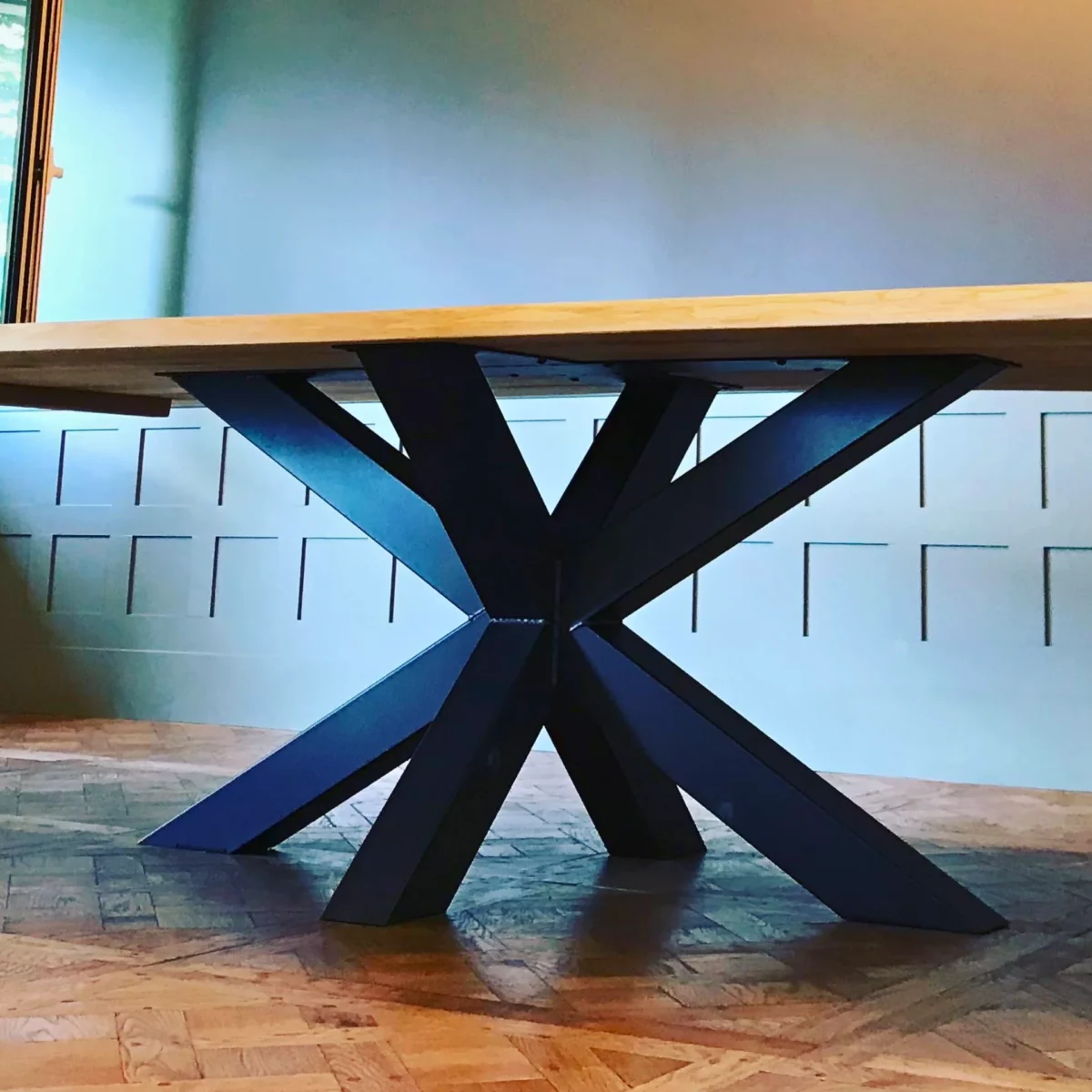 Une grand table à manger avec un pied en métal noir